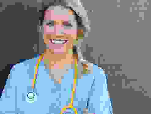 a nurse smiling looking at the camera 